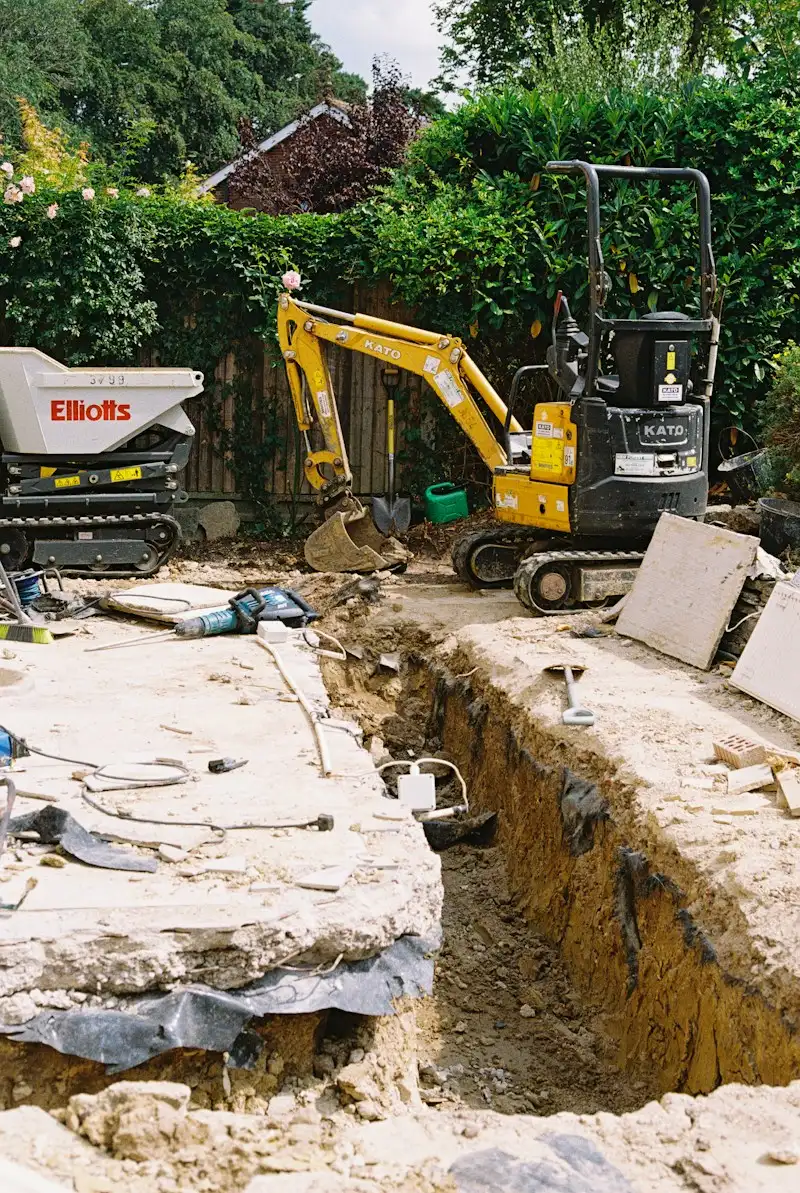 Septic system installation with a mini excavator in a residential backyard